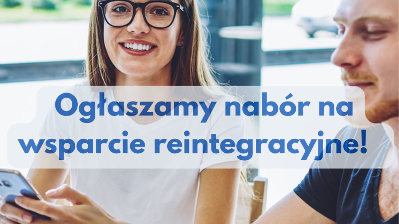 Uśmiechnięci kobieta i mężczyzna siedzą z telefonem w dłoni